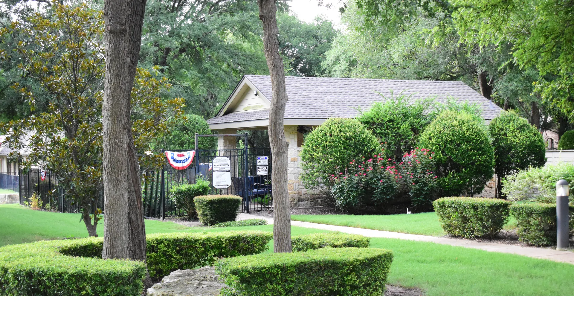 perfectly manicured hedges at gated entrance to HOA pool