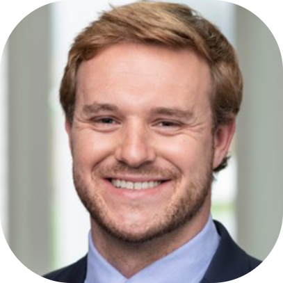 General Manager Mike Sweeney smiling headshot with blue collared shirt and jacket